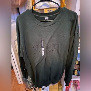 Nike Halloween crewneck, Size Medium, Dark green, Jason in a knife on it